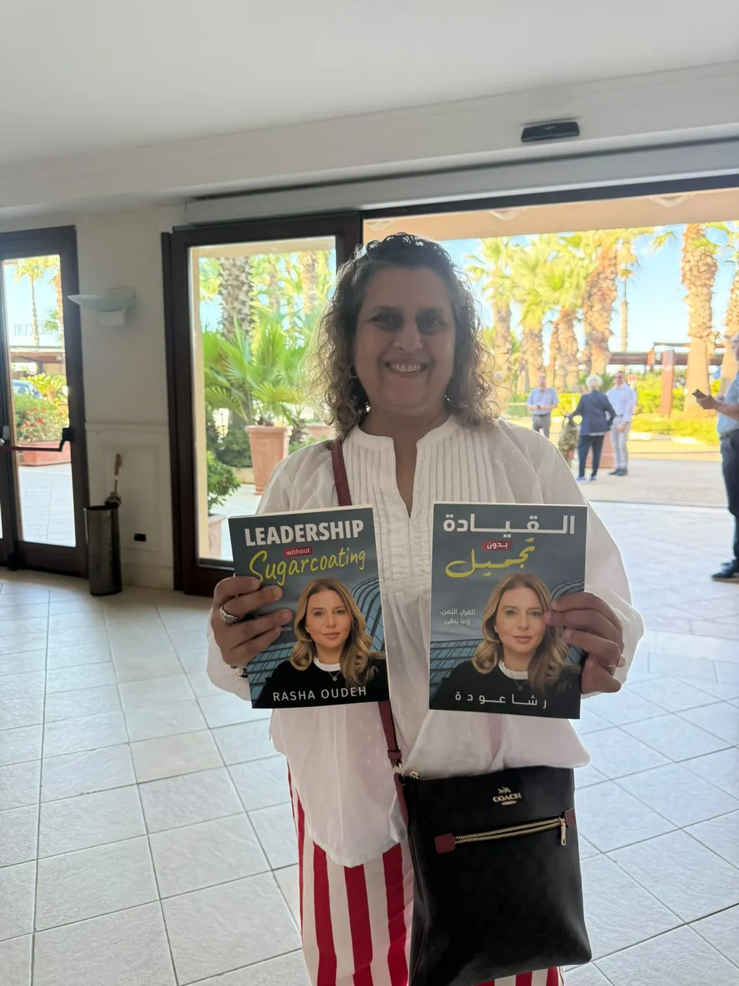 A reader with both the English and Arabic editions